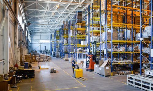 Interior of a modern warehouse storage of retail shop with pallet truck near shelves